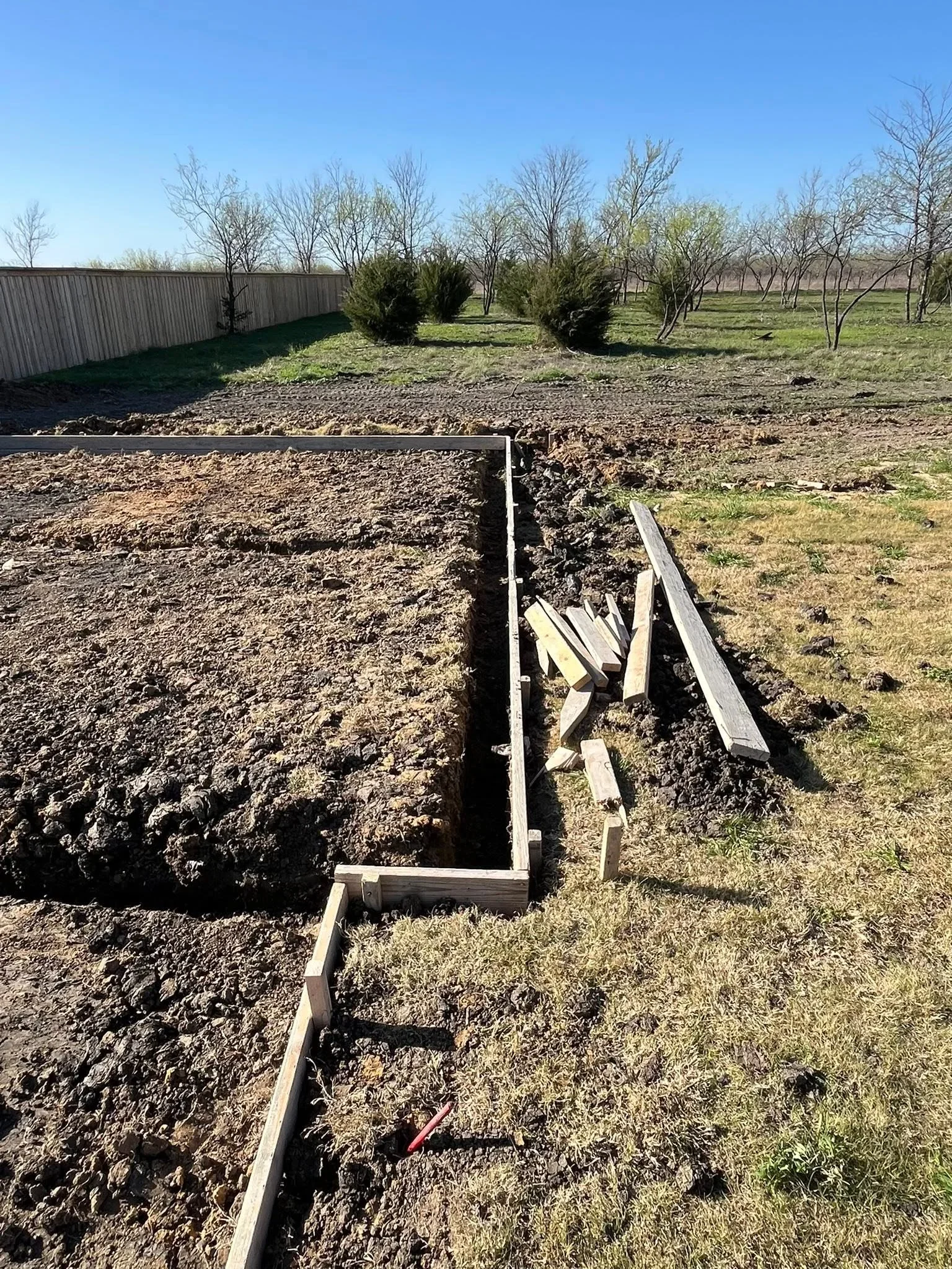 Wooden raised garden beds with soil fill and metal support bracing