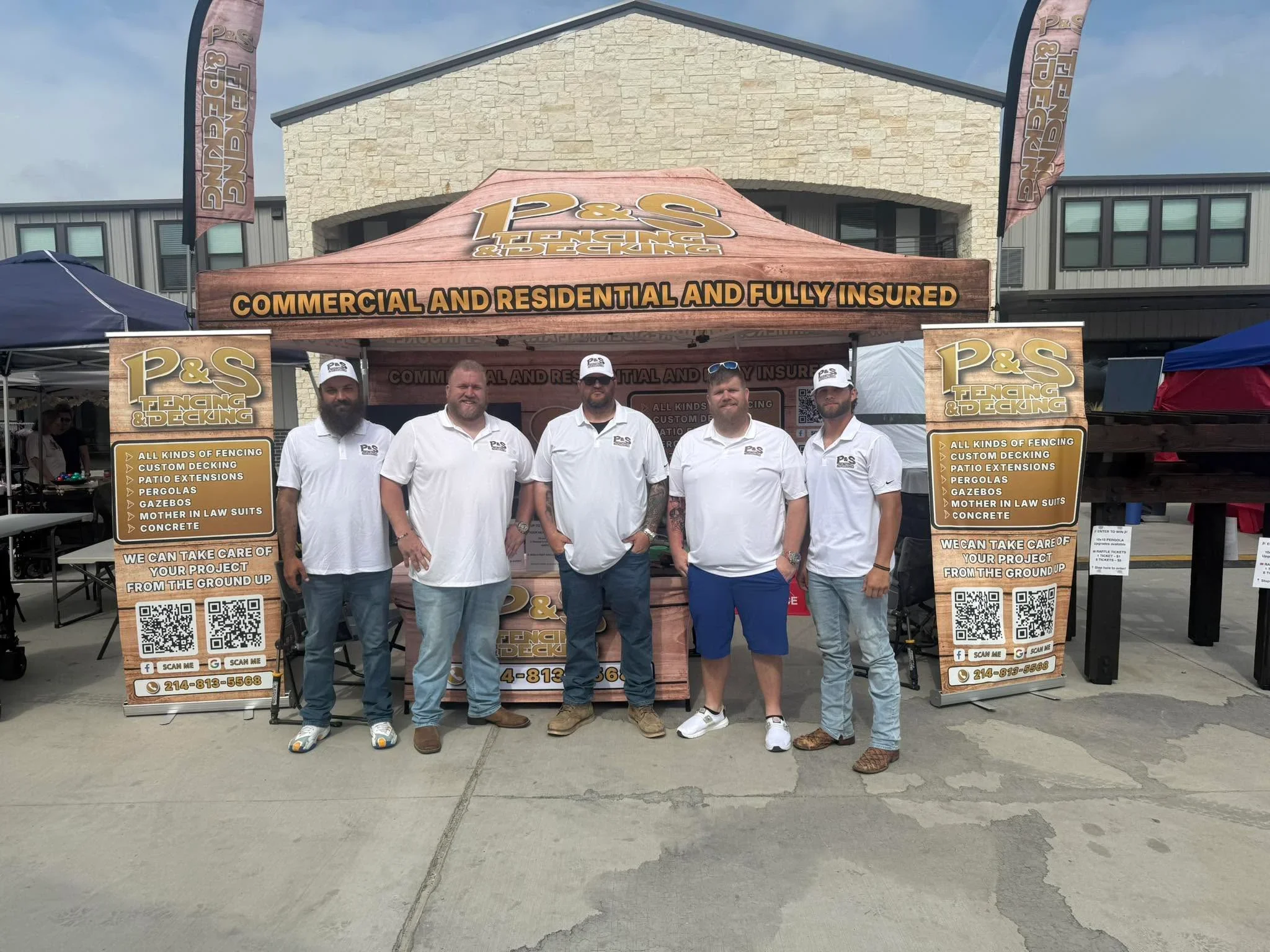 Wooden trade show booth with custom signage displaying fencing, decking, and patio services