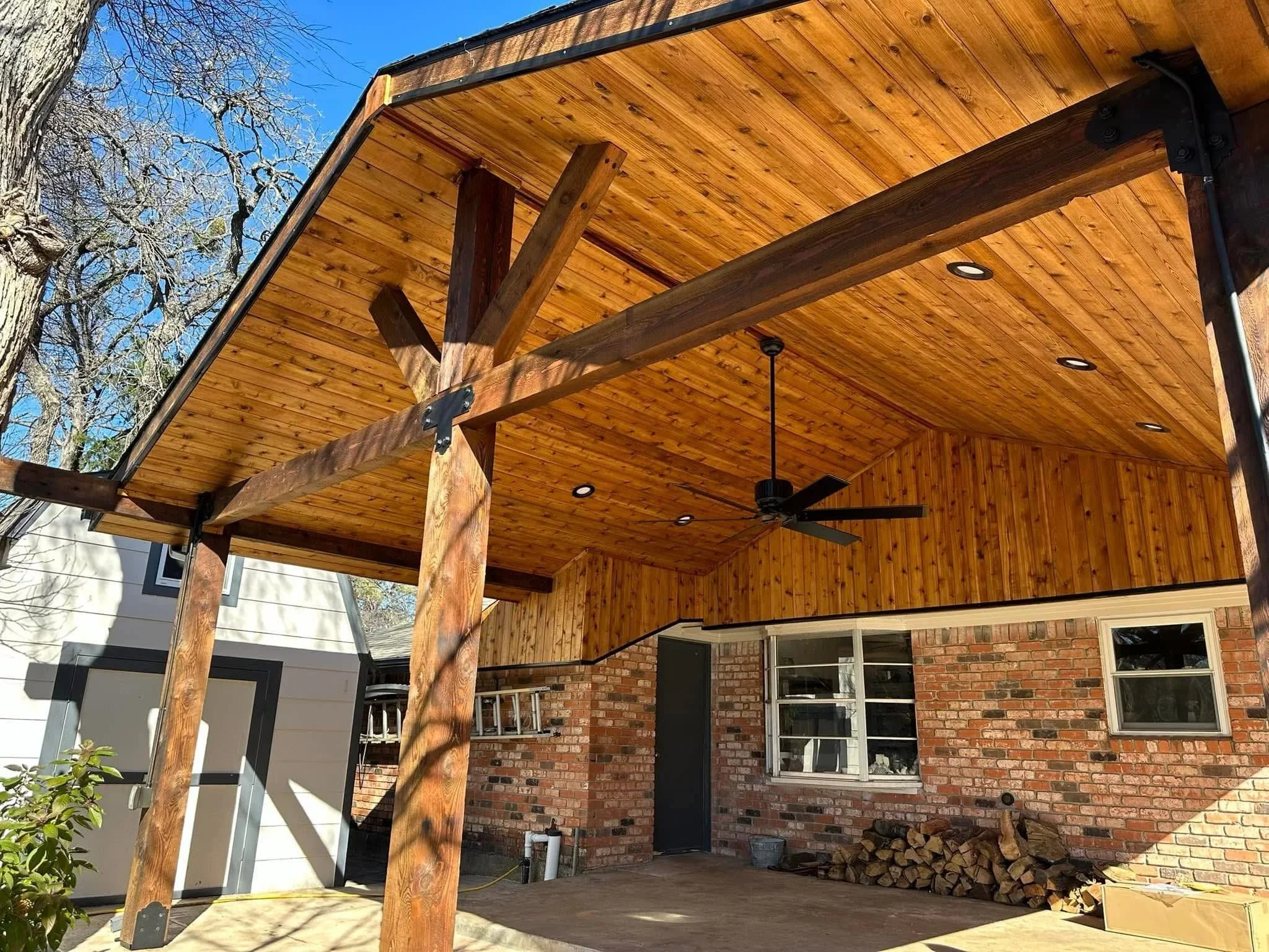Cedar pergola with exposed beams, tongue-and-groove ceiling, recessed lights, and ceiling fan