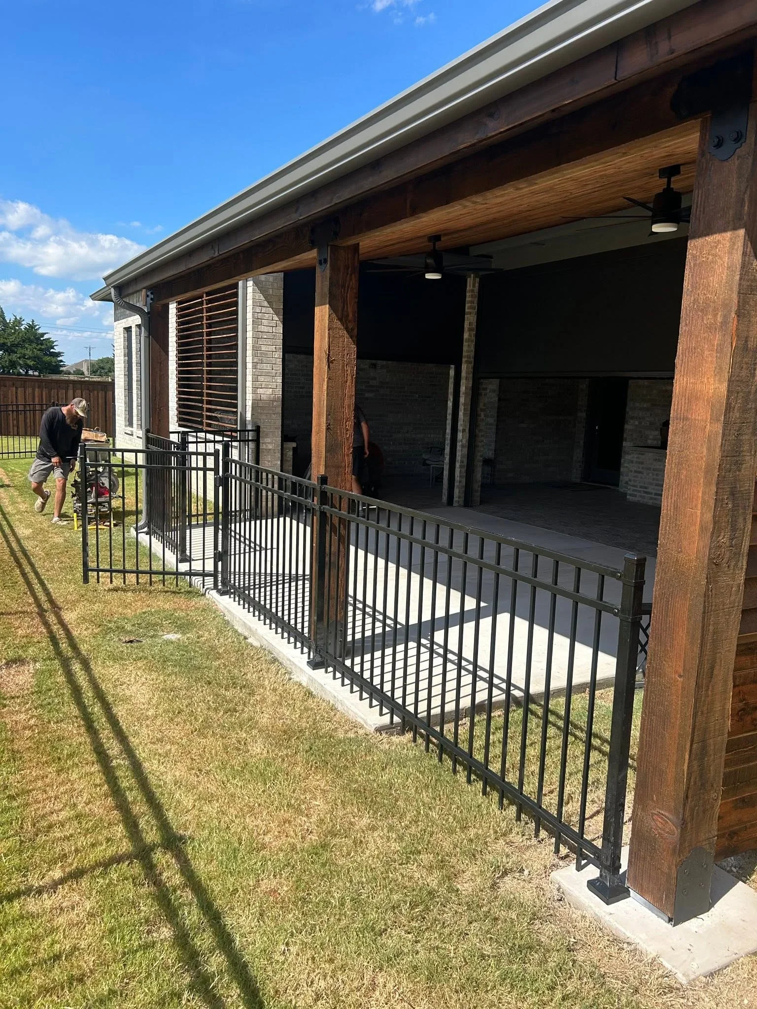 Black metal railing with horizontal pickets and timber posts on residential deck