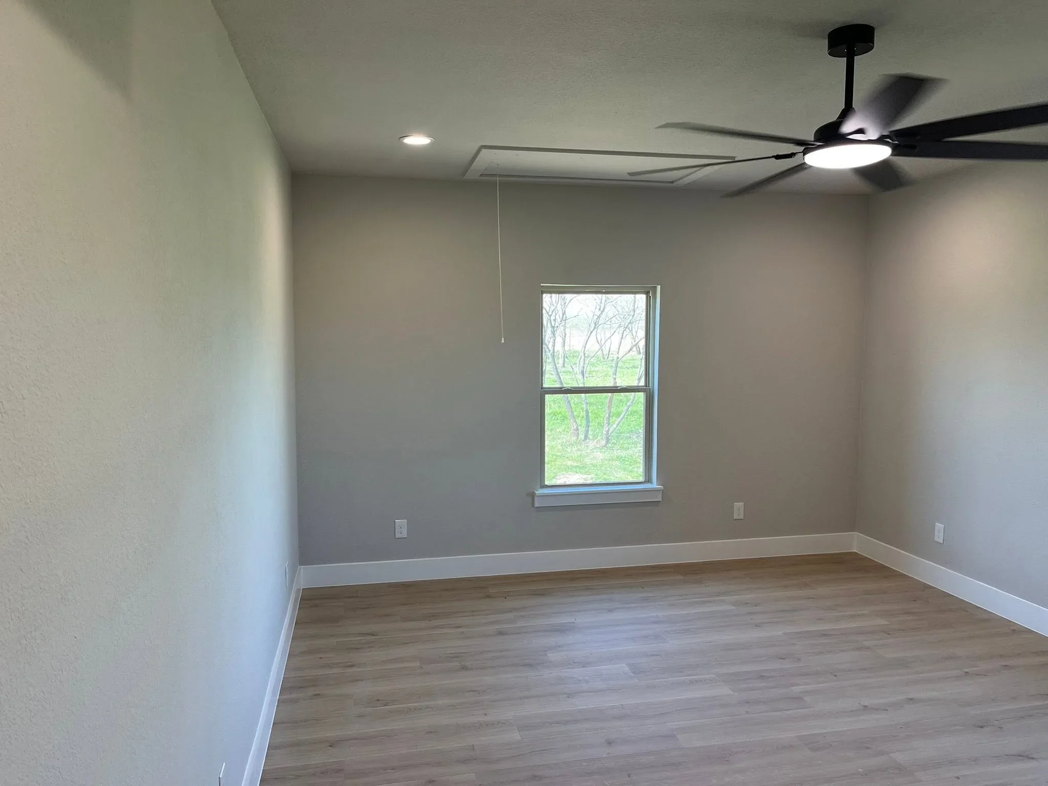 Finished interior room with drywall, recessed lighting, ceiling fan, vinyl flooring, and white trim