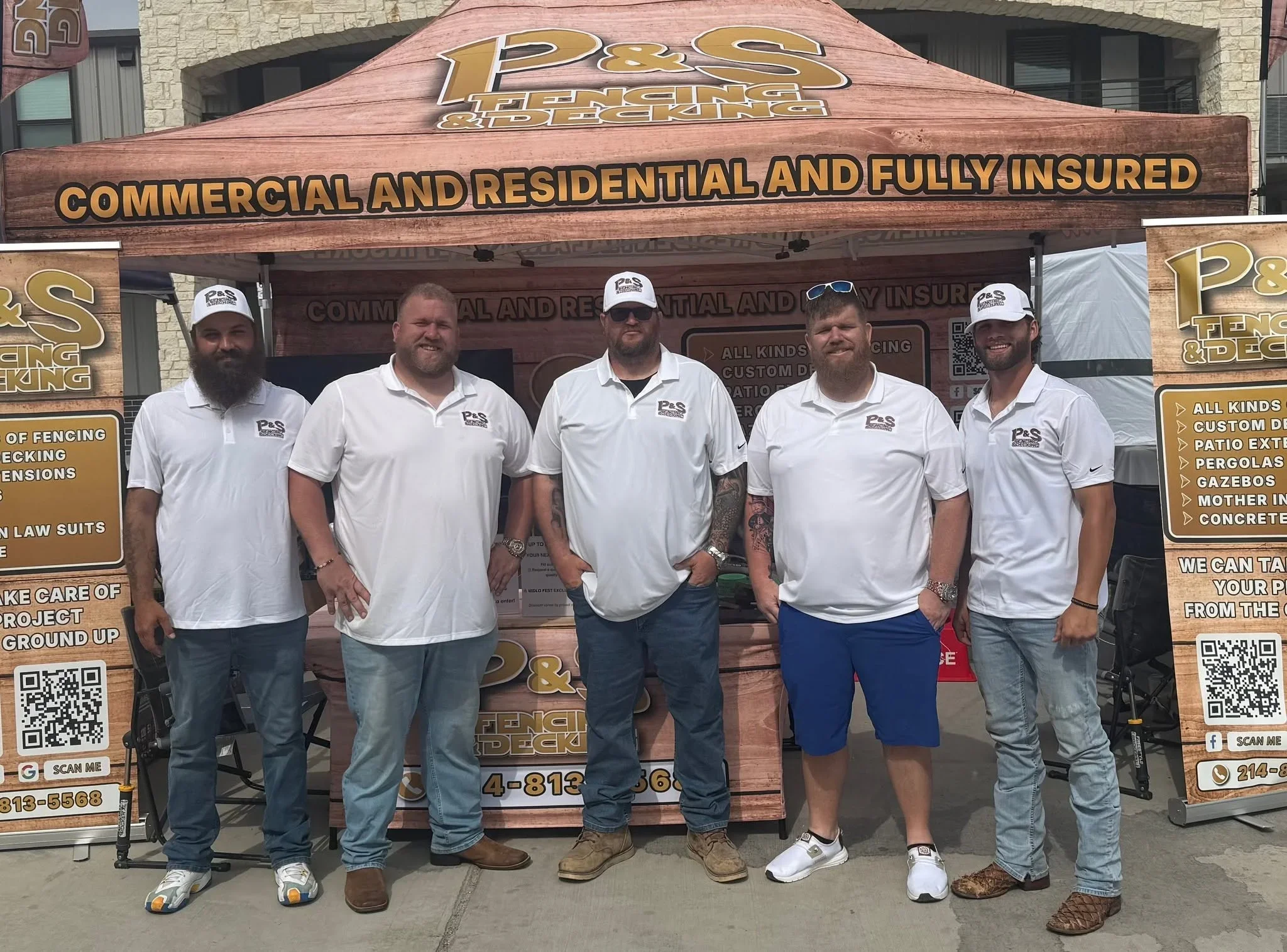 Five team members in white P&S branded polo shirts standing in front of wooden storefront signage