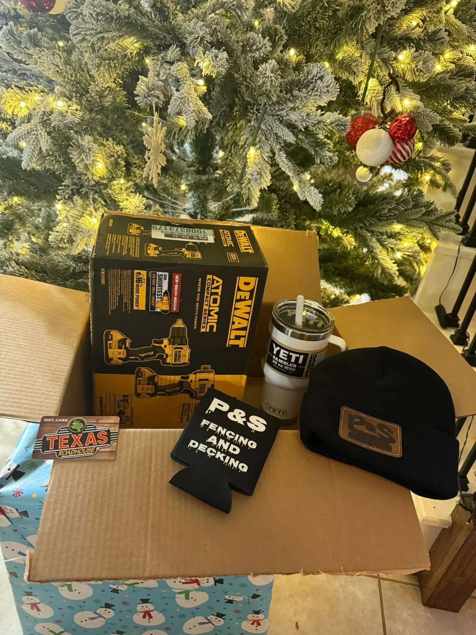 DeWalt tool box, YETI tumbler, black cap, and branded merchandise in cardboard box