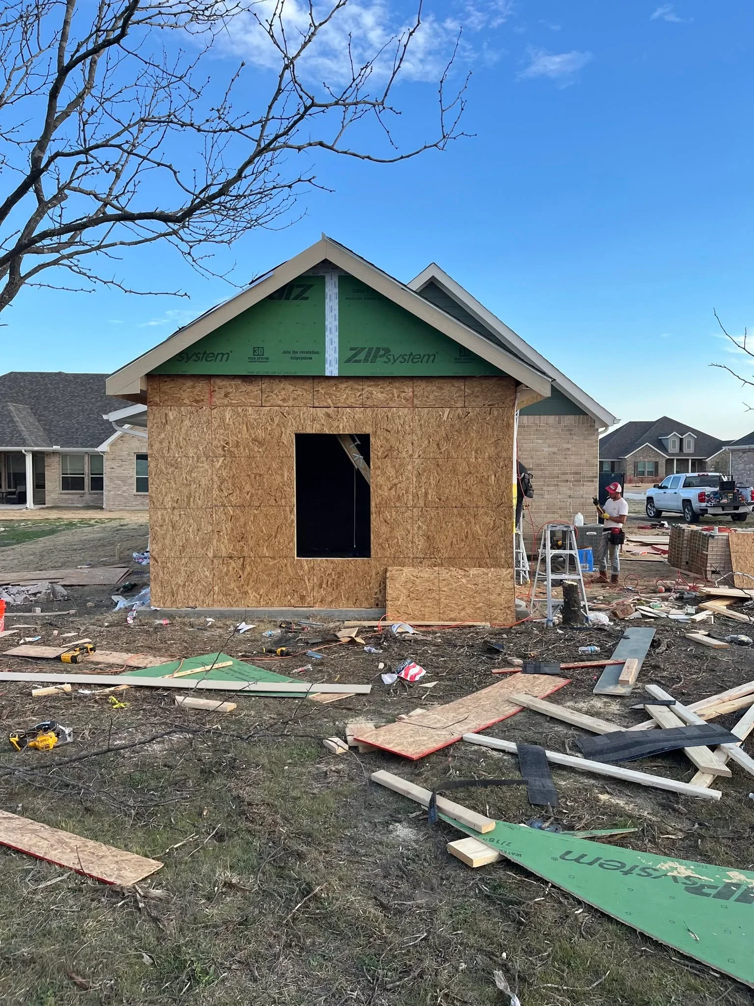 New home addition framing with OSB sheathing and ZIP System weather barrier, gable roof structure