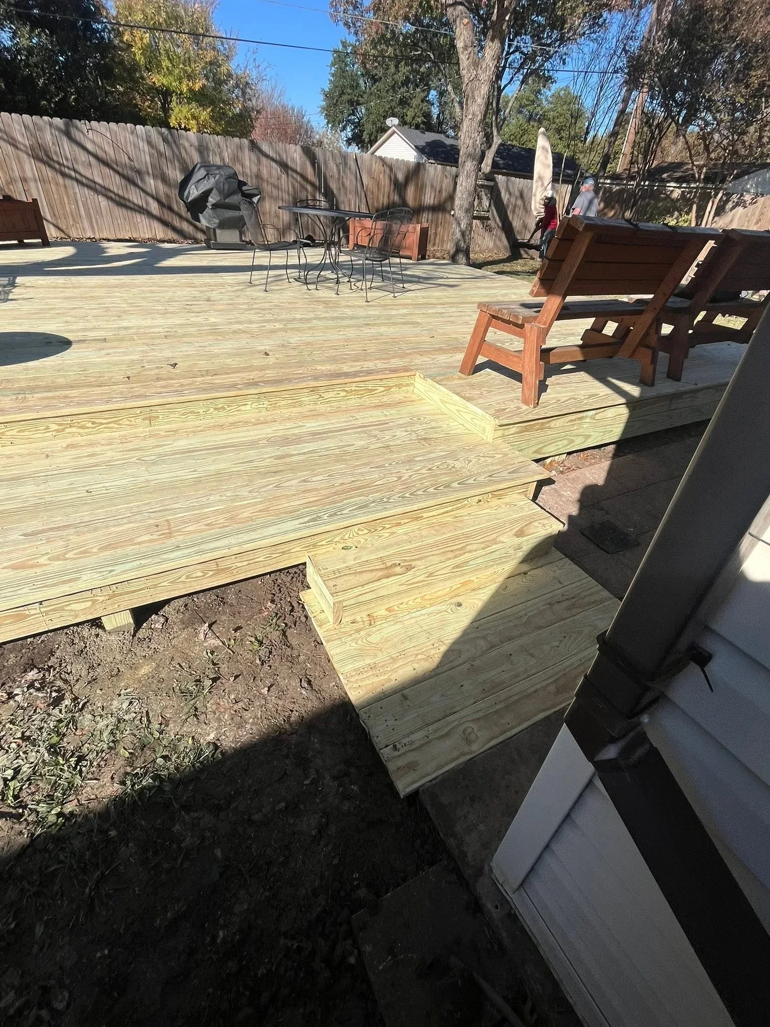 Pressure-treated wood deck framing with joists and beams during construction phase