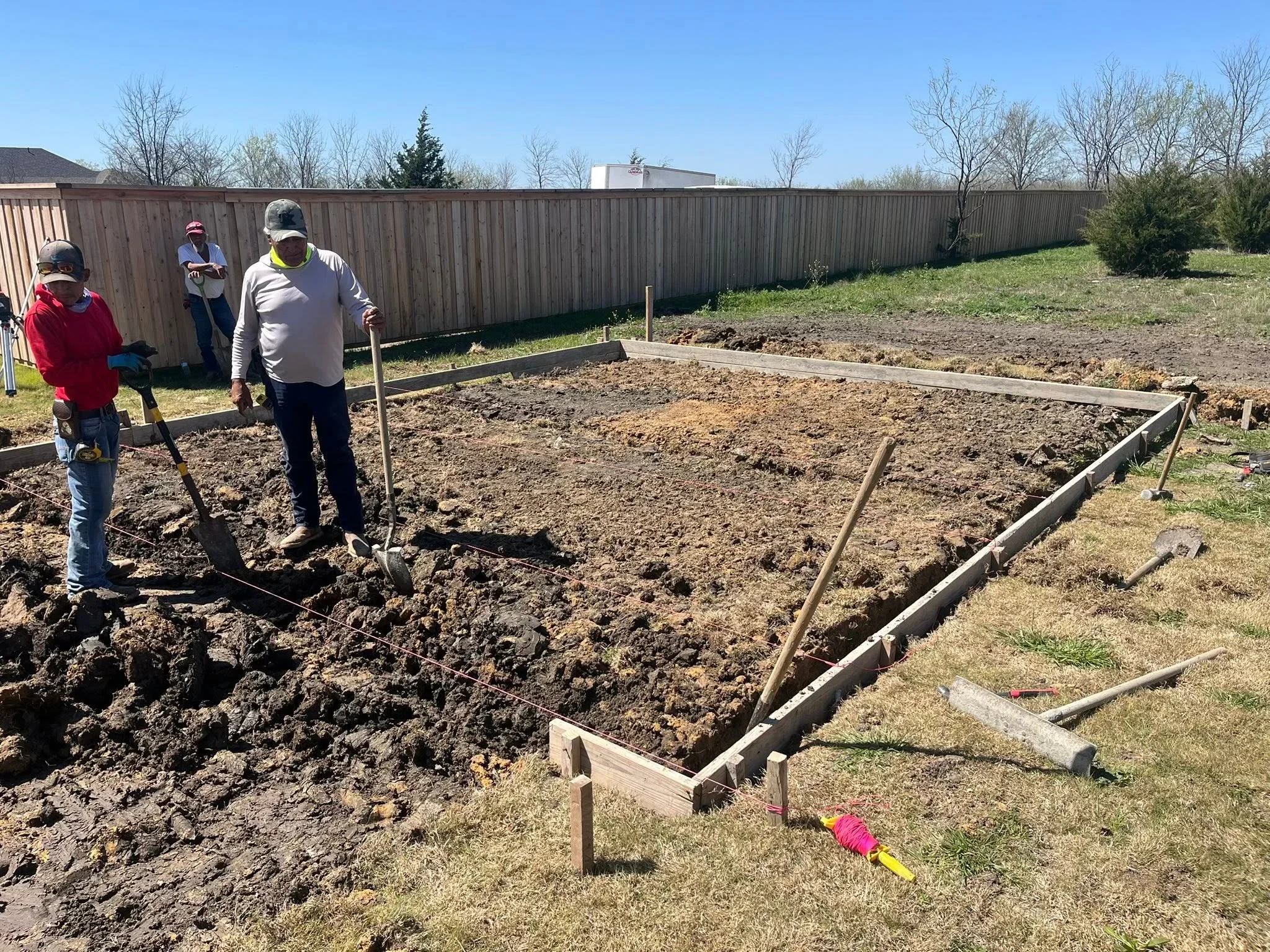 Wooden raised garden beds with timber framing during installation and soil preparation