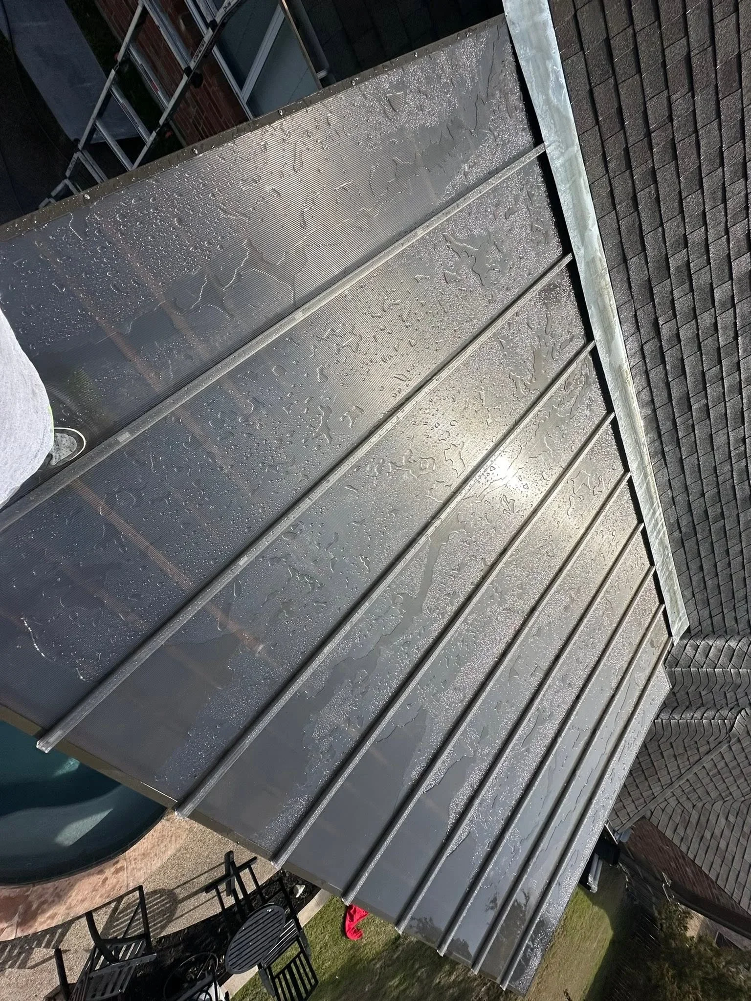Composite deck boards with metal frame and aluminum trim installed on residential structure